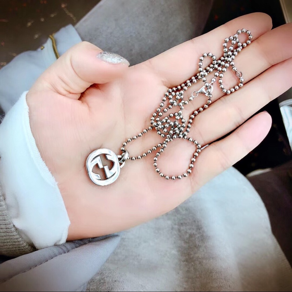 Double G silver necklace.